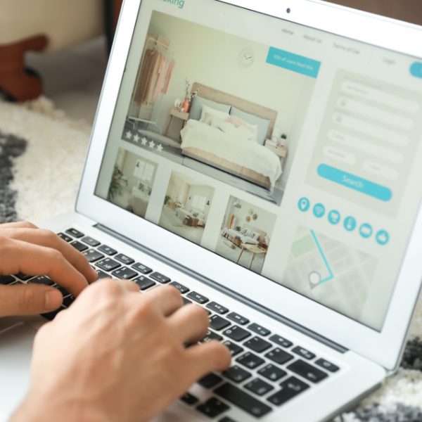 Guest booking a hotel room online, representing OTA dependency and direct booking strategy