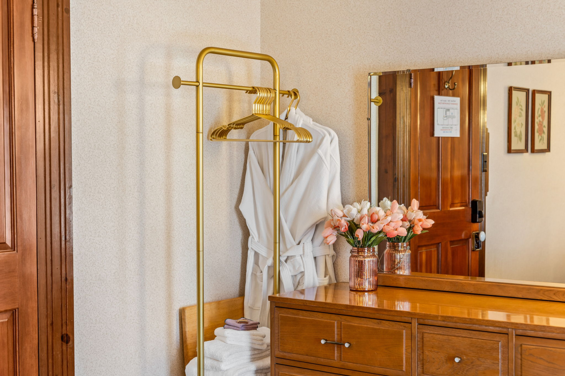 Robes and fresh flowers in a guest room at The Wildflower Hotel
